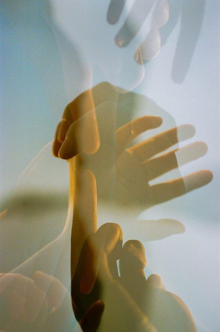 A woman with her eyes closed and hand resting on her chest, practising somatic awareness during a nervous system reset